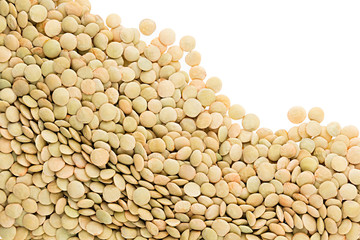 Border of green lentil closeup with copy space on white background. Isolated. Healthy protein food.