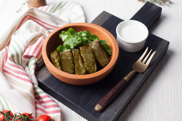 dolma with parsley and sour cream still life in a crock