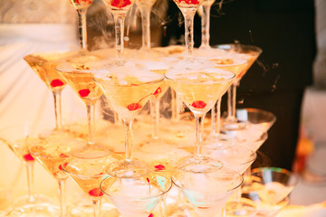 Champagne glasses. Wedding slide champagne for bride and groom. Colorful wedding glasses with champagne. Catering service. Catering bar for celebration. Beauty of bridal interior for wedding 