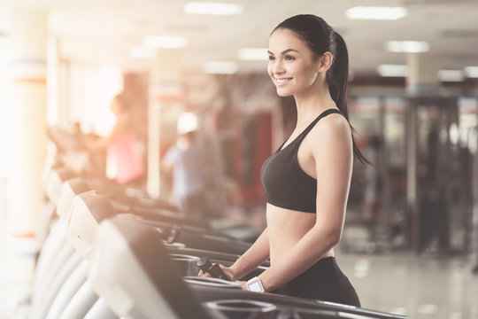 Overjoyed woman smiling in a gym.