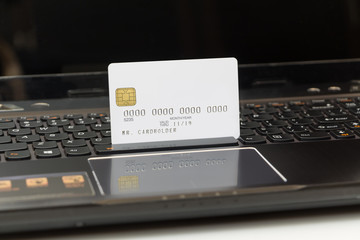 White credit card on laptop, online shopping concept