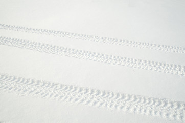 Tire tracks in fresh snow in winter