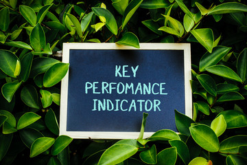 mini blackboard over the green nature written Key Performance Indicator