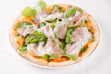 Prosciutto pizza on dish