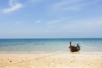 Fototapeta na wymiar Boat On Beautiful Tropical Sand Beach