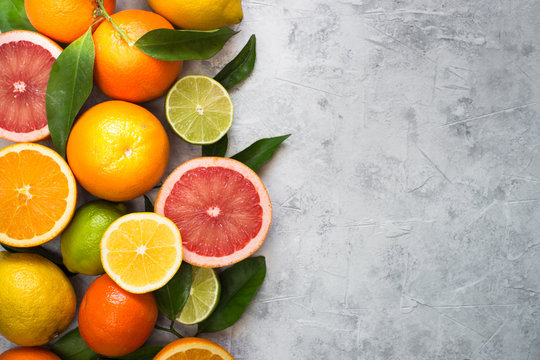 Citrus fruit on grey concrete table. Food background. Healthy eating © nadianb