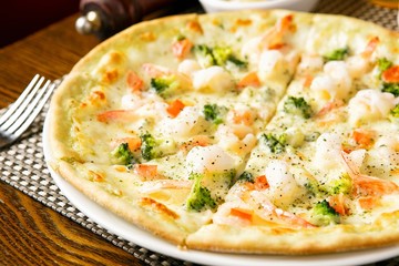 shrimp pizza on table