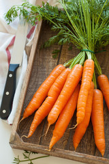 raw carrot vegetable on wooden chopping board