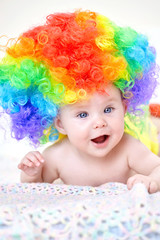 smiling baby girl with colorful wig