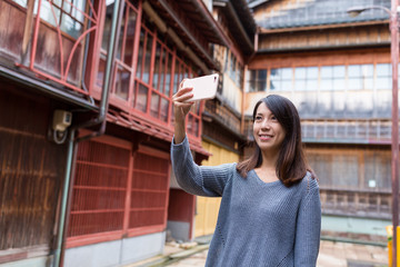 Young woman taking photo by mobile phone