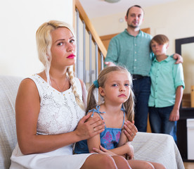 Parents and two kids in conflict at home.