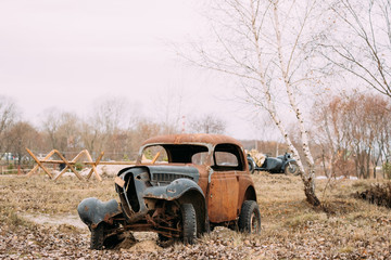 Obraz na płótnie Canvas Old Broken Rusty Car Abandoned During Second World War