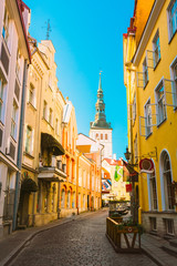 Fototapeta na wymiar Tallinn, Estonia. View Of Narrow Street In Sunny Summer Day Under Blue Sky