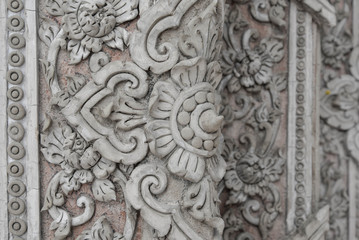 Plaster carvings of Thai style on the temple wall
