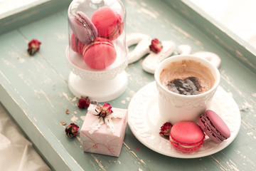 Obraz na płótnie Canvas romantic breakfast in bed. Cappuccino ,strawberry macaroons ,gift box on wooden blue table. Valentine's day concept