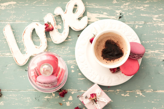 romantic breakfast in bed. Cappuccino ,strawberry macaroons ,gift box on wooden blue table. Valentine's day concept