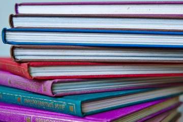  pile of multicolored hardcover books