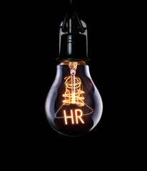Hanging lightbulb with glowing HR concept.