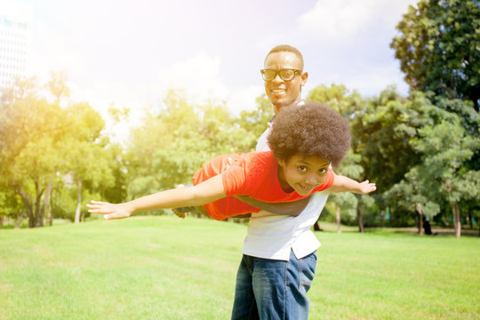 African American Family Having Fun In The Outdoor Park During Summer