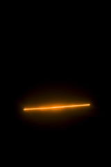 Laser beam orange on a black background