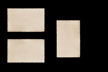 Obraz premium Three blank vintage photos with jagged edges on the black background. Two horizontally and one vertically are ready for your text. 