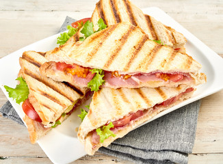 Plated of toasted or grilled ham sandwiches