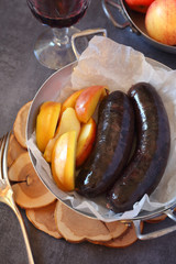  French cuisine: Blood sausage, apples and glass of red wine