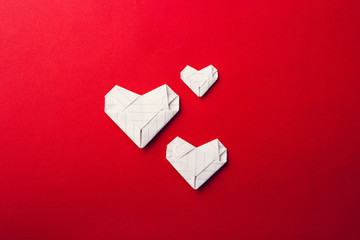 Paper heart on red background