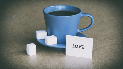 cup of coffee and sugar, the words on the white sticker