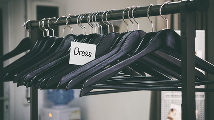 many black hangers for clothes, words on a white sticker