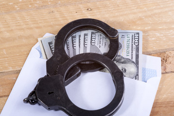 Handcuffs and dollar bills