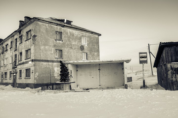 Bus station with New Year firtree and house in Teriberka, Murmansk Region, Russia