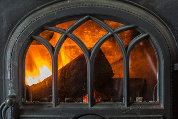 Closeup of burning fire wood in home fireplace.