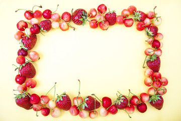 Frame made from fruits on a yellow background