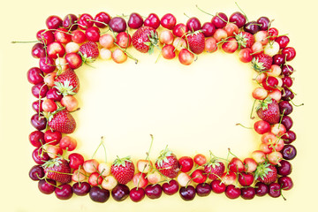 Frame made from fruits on a yellow background