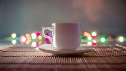 cup of coffee standing on a bamboo napkin 