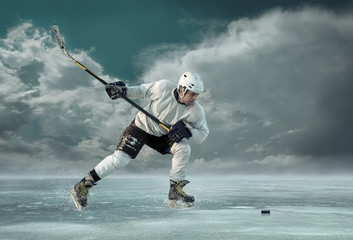 Ice hockey player in action outdoor around mountains