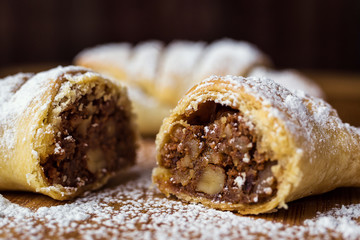 tasty croissants with chocolate and with condensed milk sprinkled with powdered sugar.Delicious continental breakfast with croissants,close up on the croissants.homemade croissants.croissant inside