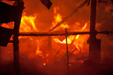 Firemen extinguish a house and building;