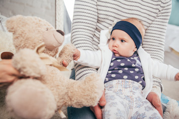 Adorable two month old baby girl lying on the pillow and looking into the camera