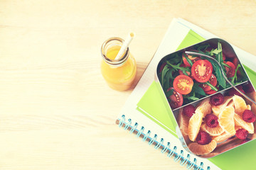 Lunch box with tomato salad and fruits 