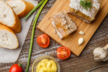 Homemade jelly meat with mustard, bread, tomatoes and garlic on the table. Holodets