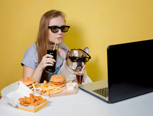 Girl and dog eating fast food