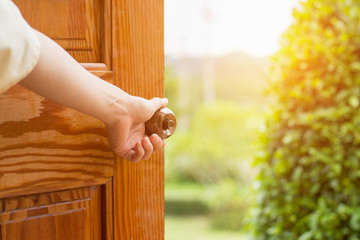 Women hand open door knob or opening the door.