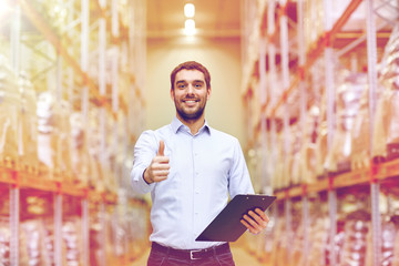 happy man at warehouse showing thumbs up gesture