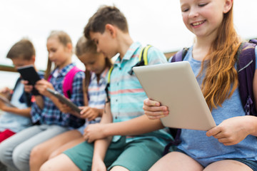 close up of elementary students with tablet pc