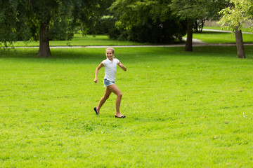 happy girl running and playing at summer outdoors