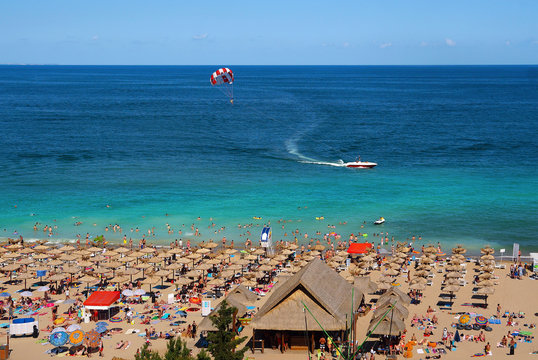 Resort Sunny Beach Bulgaria panorama of the beach in summer. Panoramic top view Sunny Beach Bulgaria. The boat and a parachute into the sea.