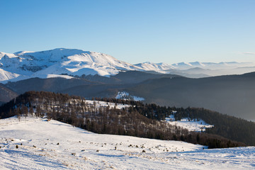 Fototapeta na wymiar Sunset in the winter, snowy mountains and ski