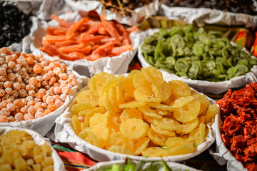 View of dried fruits and nuts in market. Various assortment colorful background